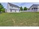 Large backyard with grassy lawn and fence in the background offer great outdoor living space at 6541 Hasley Woods Dr, Huntersville, NC 28078