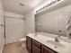 Well-lit bathroom with double sink vanity, tiled floors, and a shower with patterned curtain at 6541 Hasley Woods Dr, Huntersville, NC 28078