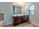 Bathroom features double sink vanity with storage and large mirror with updated vanity lighting at 6541 Hasley Woods Dr, Huntersville, NC 28078