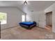 Bright bedroom features vaulted ceiling, neutral carpet and two windows for lots of natural light at 6541 Hasley Woods Dr, Huntersville, NC 28078