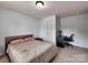 Cozy bedroom featuring neutral walls, carpeted floors, and a functional workspace for comfortable living at 6541 Hasley Woods Dr, Huntersville, NC 28078