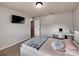 Cozy bedroom featuring a wall-mounted TV, desk, carpeted floors, and a window for natural light at 6541 Hasley Woods Dr, Huntersville, NC 28078
