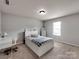 Comfortable bedroom featuring a white bed frame, a desk, carpeted floors, and a window with natural light at 6541 Hasley Woods Dr, Huntersville, NC 28078
