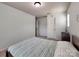 Neutral bedroom featuring matching bed and nightstand and a single window for natural light at 6541 Hasley Woods Dr, Huntersville, NC 28078
