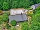 Aerial view of community pool and pool house surrounded by lush greenery and neighborhood homes at 6541 Hasley Woods Dr, Huntersville, NC 28078