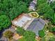 Aerial view of a community pool with blue lanes, kiddie pool, pool house, and surrounding trees at 6541 Hasley Woods Dr, Huntersville, NC 28078