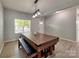 A well-lit dining room with a large window, unique table, and neutral wall color, creating an inviting space at 6541 Hasley Woods Dr, Huntersville, NC 28078