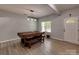 Bright dining room with gray vinyl flooring and a modern light fixture over a stylish dining table and bench set at 6541 Hasley Woods Dr, Huntersville, NC 28078