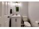 A compact half bathroom with a white vanity, modern mirror, and a neutral color scheme at 6541 Hasley Woods Dr, Huntersville, NC 28078