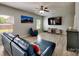Comfortable living room featuring a blue leather sectional, ceiling fan and a wall-mounted tv at 6541 Hasley Woods Dr, Huntersville, NC 28078