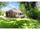 Expansive backyard with lush green grass, mature trees, and a wooden deck, offering a private and serene outdoor space at 7587 Long Valley Dr, Harrisburg, NC 28075