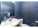 Small bathroom featuring blue wallpaper, toilet, and sink at 7587 Long Valley Dr, Harrisburg, NC 28075