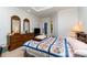 Bright bedroom with blue quilt and two dressers with mirrors, offering a cozy and inviting space at 7587 Long Valley Dr, Harrisburg, NC 28075