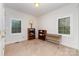 Bedroom with carpet, neutral paint, two windows, and two bookshelves at 7587 Long Valley Dr, Harrisburg, NC 28075