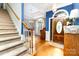 Inviting entryway with hardwood floors, staircase, and decorative floral wallpaper accent wall at 7587 Long Valley Dr, Harrisburg, NC 28075