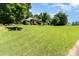A well-manicured front lawn showcasing a beautiful brick home with classic architecture and a serene, tree-lined setting at 7587 Long Valley Dr, Harrisburg, NC 28075