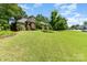 Inviting front lawn with a well-maintained garden and a charming brick home, creating a welcoming and picturesque curb appeal at 7587 Long Valley Dr, Harrisburg, NC 28075