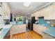 Bright kitchen features light wood cabinets, stainless steel refrigerator and a window overlooking the backyard at 7587 Long Valley Dr, Harrisburg, NC 28075