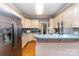 Kitchen with stainless steel refrigerator, light wood cabinets and a breakfast bar at 7587 Long Valley Dr, Harrisburg, NC 28075