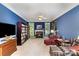 Comfortable living room featuring a fireplace, a bookshelf, and plenty of natural light at 7587 Long Valley Dr, Harrisburg, NC 28075