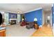 Cozy living room with fireplace, plush seating, and bright natural light from bay windows at 7587 Long Valley Dr, Harrisburg, NC 28075