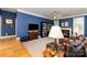Comfortable living room with fireplace, bookshelf, and stylish blue accent wall at 7587 Long Valley Dr, Harrisburg, NC 28075