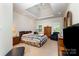 Primary bedroom featuring tray ceiling, windows, and furnishings at 7587 Long Valley Dr, Harrisburg, NC 28075