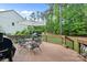 Spacious back deck with outdoor dining set, a grill, and lush backyard views at 7687 Bermuda Hills Ln, Denver, NC 28037