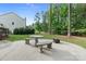 Backyard patio with seating and a firepit, creating a welcoming space for relaxation at 7687 Bermuda Hills Ln, Denver, NC 28037