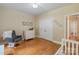 Neutral-toned bedroom with a dresser, a gray chair, and a built-in closet for ample storage at 7687 Bermuda Hills Ln, Denver, NC 28037