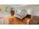 Bedroom featuring hardwood floors, a tray ceiling, neutral tones and natural light at 7687 Bermuda Hills Ln, Denver, NC 28037