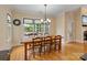 Dining room with large windows and natural light, wooden table and seating for six at 7687 Bermuda Hills Ln, Denver, NC 28037