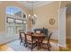 Formal dining room with large windows, elegant decor, and comfortable seating for Gathering and guests at 7687 Bermuda Hills Ln, Denver, NC 28037
