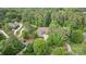 Gorgeous aerial view of a stone and siding home with mature trees and landscaping at 7687 Bermuda Hills Ln, Denver, NC 28037