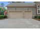 Three car garage, neutral colors, with well maintained driveway at 7687 Bermuda Hills Ln, Denver, NC 28037