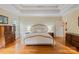 Bright bedroom with wood floors, large windows, dresser, nightstands and tray ceiling at 7687 Bermuda Hills Ln, Denver, NC 28037