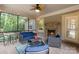 Relaxing screened porch with comfortable seating and a cozy stone fireplace for year-round enjoyment at 7687 Bermuda Hills Ln, Denver, NC 28037