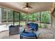 Inviting screened porch with stylish furniture, creating a perfect space for outdoor relaxation at 7687 Bermuda Hills Ln, Denver, NC 28037