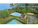 Aerial view showcasing the community pool, clubhouse, tennis court and sand volleyball court with lake access at 7687 Bermuda Hills Ln, Denver, NC 28037