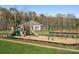 Community playground with play structure and swing set, set in a grassy area with trees at 829 Hallman Branch Ln, Lincolnton, NC 28092