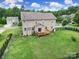 Large backyard featuring a well-maintained lawn, a wooden deck, and a secure fence at 9029 Woodview Ct, Fort Mill, SC 29707