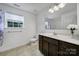 Well-lit bathroom with a single vanity, clean white fixtures, and a window providing natural light and ventilation at 9029 Woodview Ct, Fort Mill, SC 29707