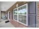 Brick exterior with large windows and dark shutters add charm to this home with an inviting entryway at 9029 Woodview Ct, Fort Mill, SC 29707