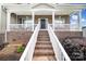 Inviting front porch and brick stairway with a view of the house number at 9029 Woodview Ct, Fort Mill, SC 29707