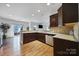 Open-concept kitchen with stainless steel appliances, granite countertops, and a seamless transition to the living area at 9029 Woodview Ct, Fort Mill, SC 29707