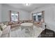 Cozy living room area featuring a custom seating area, plush carpeting, and natural light from the windows at 9029 Woodview Ct, Fort Mill, SC 29707