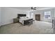 Spacious main bedroom features neutral colors, bench, ceiling fan and large windows for lots of natural light at 9029 Woodview Ct, Fort Mill, SC 29707