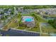 Aerial view of the neighborhood pool, tennis court, park, and clubhouse at 9159 Marasol Ln, Concord, NC 28027