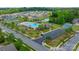 Community aerial view of the pool, park, tennis courts, and pond at 9159 Marasol Ln, Concord, NC 28027