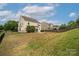 Spacious backyard with a patio area, fire pit, and black metal fencing at 9159 Marasol Ln, Concord, NC 28027